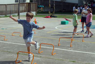 Student jumping over hurdle