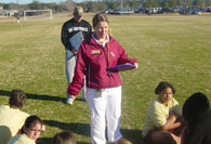 Intern teaching students on soccer field