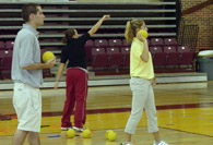 Student intern throwing a ball