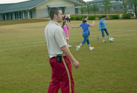 Intern watching students on soccer field