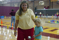Student balancing spoon and ball