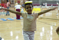 Student balancing a beanbag on her head